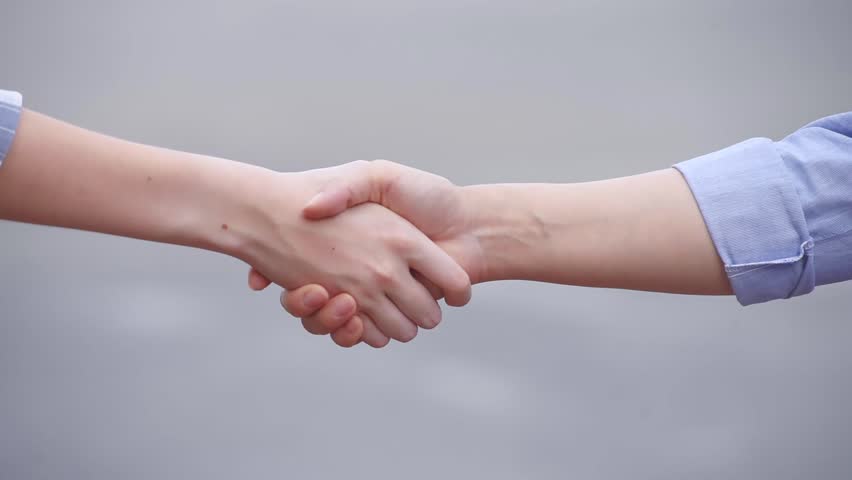two female shaking hands in casual shirts, closeup  Royalty-Free Stock Footage #28662664