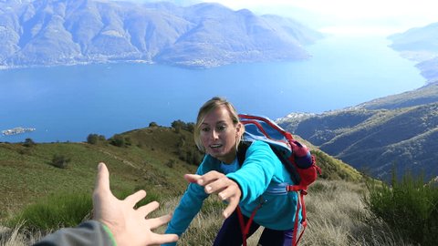 Young woman hiking reaches mountain top, outstretches arms
Woman reaching mountain top celebrates success