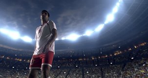4K video in slow motion of a footballer kicks the ball with his feet while jumping horizontally. The player is wearing unbranded soccer uniform. Stadium and crowd are made in 3D.