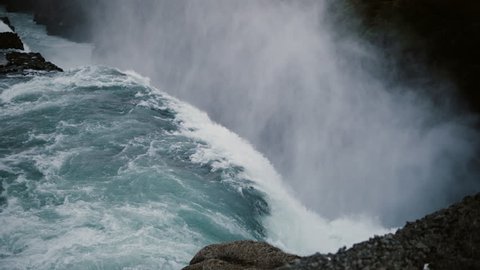 Beautiful scenic landscape of the Gullfoss waterfall in Iceland. Splashing water falling down from the cliff with foam.