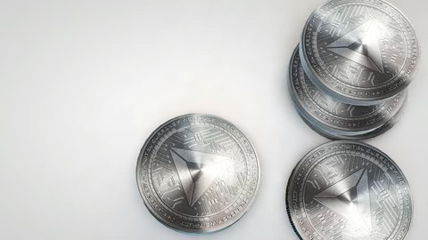 silver basic attention token coins falling on white background
