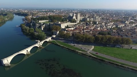 AVIGNON   FRANCE  NOV 2016 - DRONE SHOT OF THE  HISTORICAL CENTER FROM  BARTHELASSE ISLAND T UP TO SAINT-BENEZET BRIDGE TO THE POPES PALACE. FALL ATMOSPHERE IN PROVENCE.
