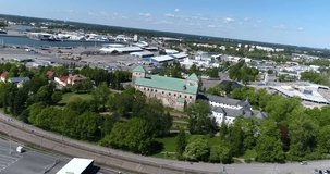 Turku castle, Cinema 4k aerial view around turun linna, revealing aurajoki river and the cityscape, on a sunny summer day, in Abo, Finland