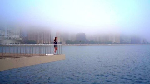 Young woman looking away on chicago river. Expectation concept. Woman waiting at chicago river. Brunette woman standing on pier beach