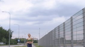 Woman in jogging suit drinks water