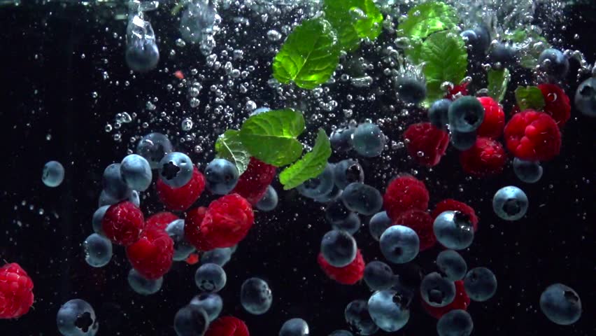 Raspberries, Blueberries and fresh mint leaves splashing into water on black background. Falling fresh fruits and berries in water. Organic berry, healthy food, diet 4K UHD video 3840X2160 slow motion | Shutterstock HD Video #28682812