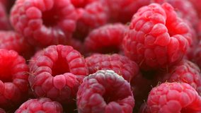 Raspberry rotation Background. Ripe fresh and juicy organic raspberries close-up. Top view. 4K UHD video 3840X2160. Rotation 360 degrees 