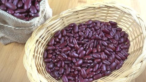 Red kidney beans pouring into basket - slow motion
