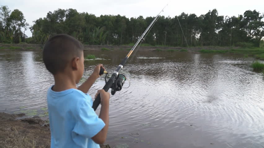 boy  fishing on river ,slow motion