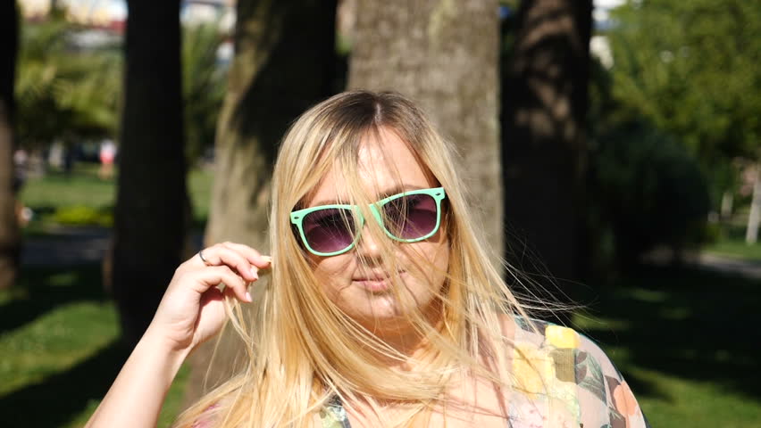A young happy girl dancing modern ballet and wacking in a summer park. slow-mo