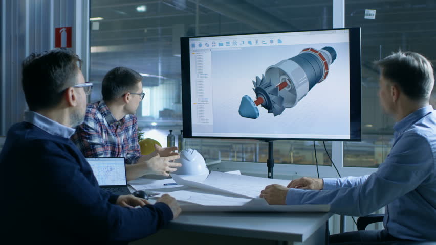 Team of Industrial Engineers Discuss 3D Model of Turbine/ Engine Design Shown on a Presentation Display. In the Background Factory is Seen. Shot on RED EPIC-W 8K Helium Cinema Camera.