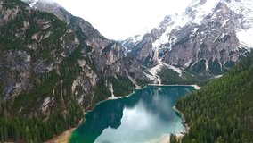 Drone aerial flying over a scenic Lago di Braies in Dolomites, Italy Alps