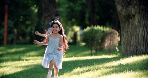 children running around in garden and laughing,slow motion