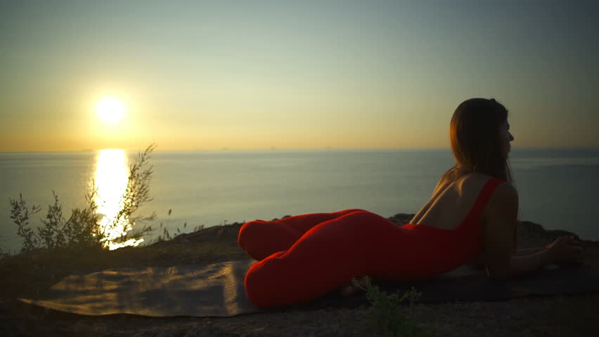 Young health woman practice yoga pose meditation coast sundown rapid slowmotion | Shutterstock HD Video #28711666