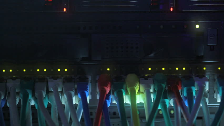 Network Hub and cables with flickering lights in a server rack toned in blue