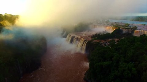 Largest waterfall in the world at sunset. Rare aerial view of Iguazu Falls, 4K