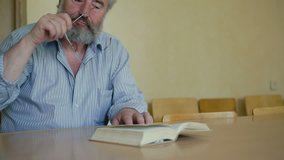 A senior man emotionally reading book through glasses 4K - Powered by Shutterstock - Get 15% off with code: PIKWIZARD15