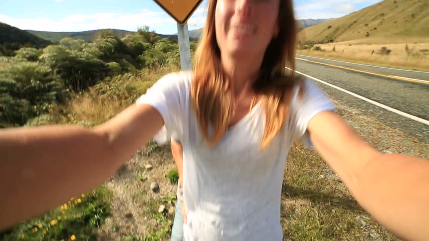 Young couple traveling take selfie portrait with Kiwi sign
Cheerful young couple take a selfie portrait on the road standing next to a kiwi warning sign, New Zealand.