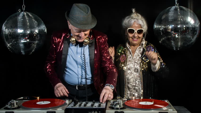 amazing DJ grandma and grandpa, older couple djing and partying in a disco setting. these retired rockers will get the party going Royalty-Free Stock Footage #28749094