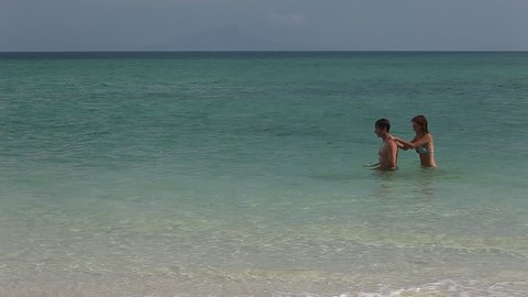 Young couple having fun in tropical sea