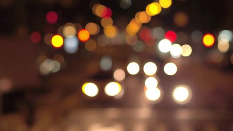 DEFOCUSED BOKEH: Traffic jam on busy road in crowded New York City street during the night. Colorful blurred car headlights and flashing traffic lights glowing in the dark creating magical atmosphere