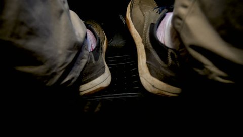 Closeup view of drivers foot presses the accelerator pedal in car