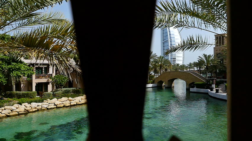 View to Burj Al Arab hotel from the shopping mall at Madinat Jumeirah, Dubai, United Arab Emirates. Middle eastern lifestyle and culture. 4k