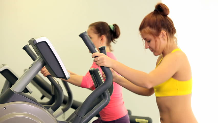 Two sporty woman training in sport gym