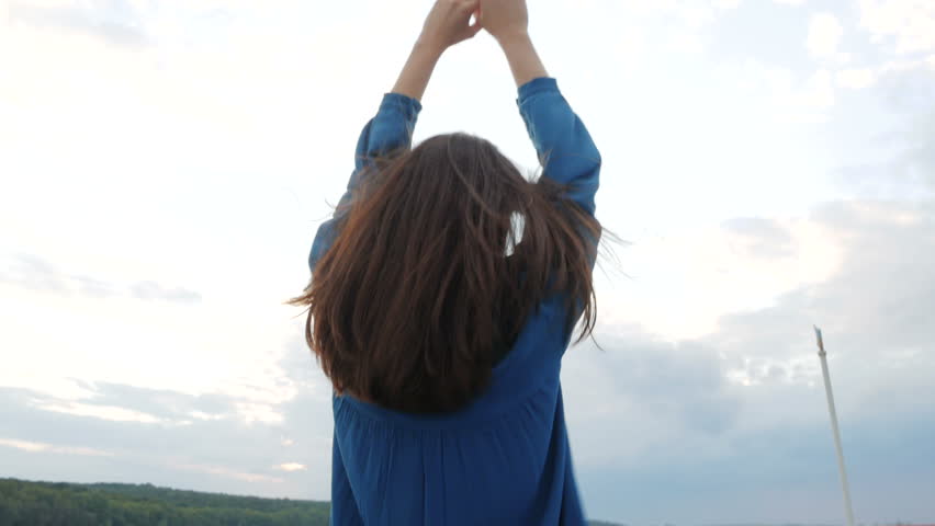 Travel, trip, vacation, tourist concept. Happy smiling young woman, female Asian mixed, traveling in a blue shirt, sailing on a passenger ship or boat in the summer on the lake sunset
