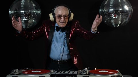 amazing DJ grandpa, older cool man djing and partying in a disco setting. these retired rockers will get the party going