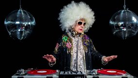 amazing DJ grandma, older lady djing and partying in a disco setting. these retired rockers will get the party going