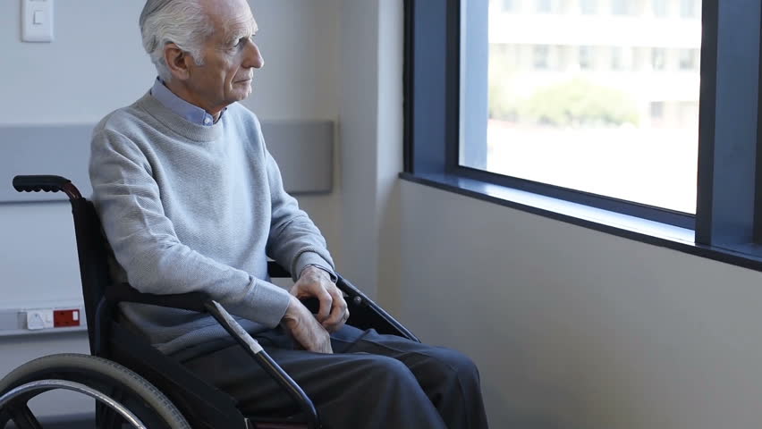Thoughtful senior man sitting on wheelchair at hospital. Sad disabled on wheelchair at the medical center feeling lonely. Retired man alone in a medical clinic. Royalty-Free Stock Footage #28765780