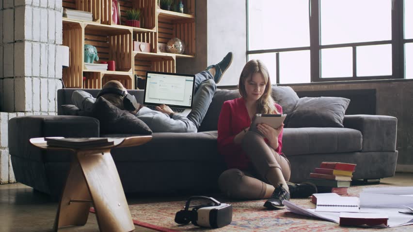 girlfriend distracts her boyfriend from freelancer work at home in the living room