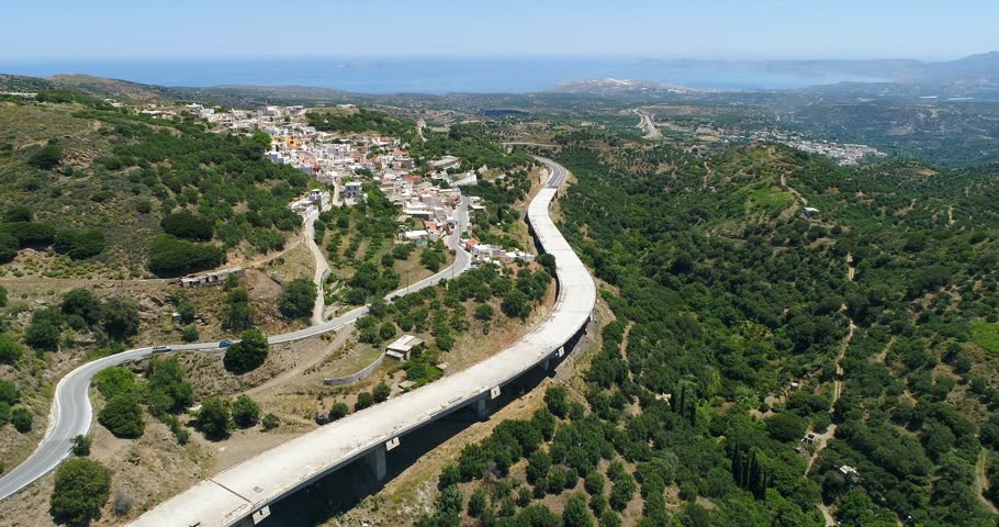 Greece. Crete. A view of the plantation of olive trees, the road and the city from a bird's eye view.