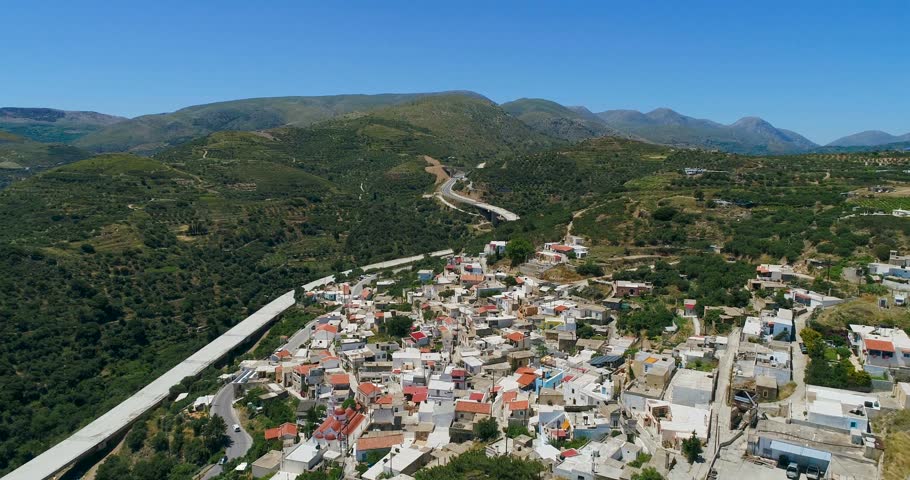 Europe. Greece. Crete. A view of the plantation of olive trees, the road and the city from a bird's eye view.
