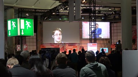 Hannover, Germany - March, 2017: 4K video footage of Edward Snowden live video conference on exhibition fair Cebit 2017 in Hannover Messe, Germany