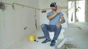 Young man with vr goggle setting up visual project of new home
