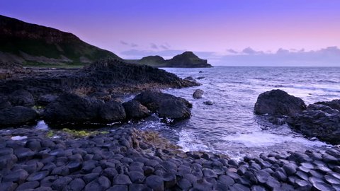 sunset over basalt rocks formation Giant's Causeway known as UNESCO World Heritage Site, County Antrim, Northern Ireland