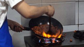 Asian traditional cooking in a wok on open fire in Seoul, Korea