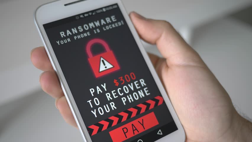 Smartphone being infected by a ransomware virus that is asking for money to retrieve the encrypted files. Royalty-Free Stock Footage #28802569