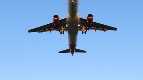 Airplane Flying Overhead against Blue Sky - Taking Off / Landing