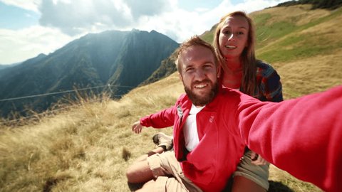 Hikers taking selfies in the mountains
Cheerful young couple hiking in summer taking a selfie on the mountain top.
