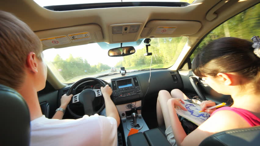 guy with girl sit on forward seat of car going on highway