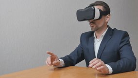 Man in virtual reality glasses. Businessman is playing online in 3d. The person uses the technology in work VR 360