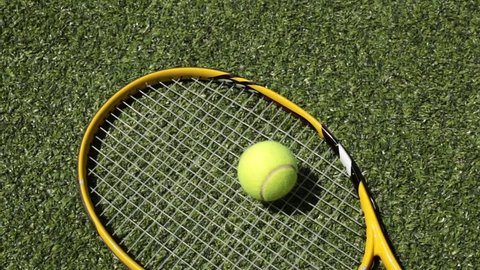 Tennis racket and ball on the grass court. Tennis and sports.