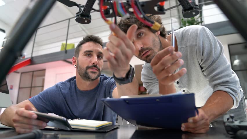 Engineer and technician working together on drone in office Royalty-Free Stock Footage #28822039