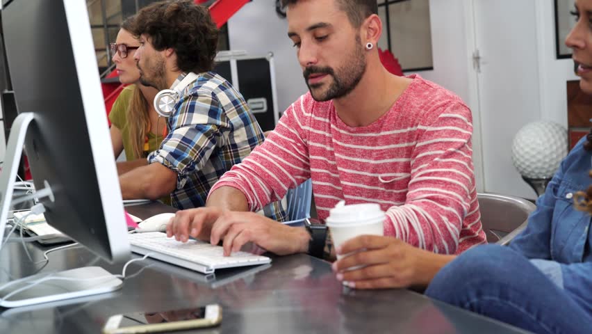 Start-up people working on desktop in co-working space