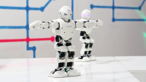 TTwo robots are dancing. Future technologies and robotics. Toy robots