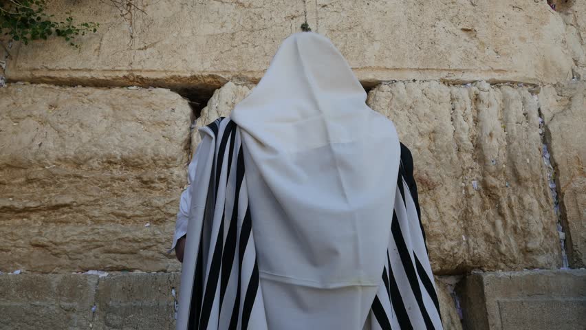Orthodox Hasidic Jew praying with a Tallit at Wailing Wall in Jerusalem ( The Western Wall of Jerusalem. ) Royalty-Free Stock Footage #28825816
