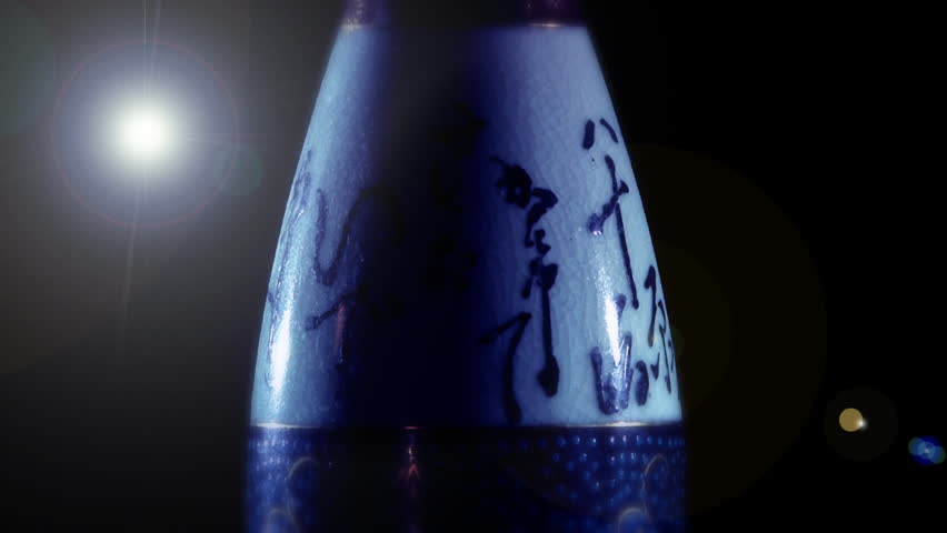 A slowly-rotating Japanese vase.  Centered with a lens flare in the upper